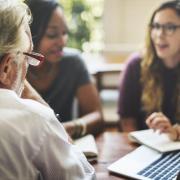 Stakeholders gather at a table.